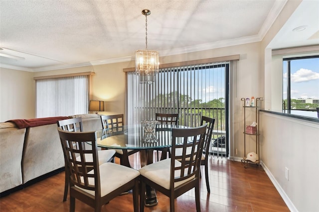 dining area with baseboards, ornamental molding, dark wood finished floors, and a textured ceiling