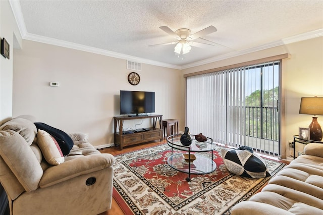 living room with ornamental molding, wood finished floors, and visible vents