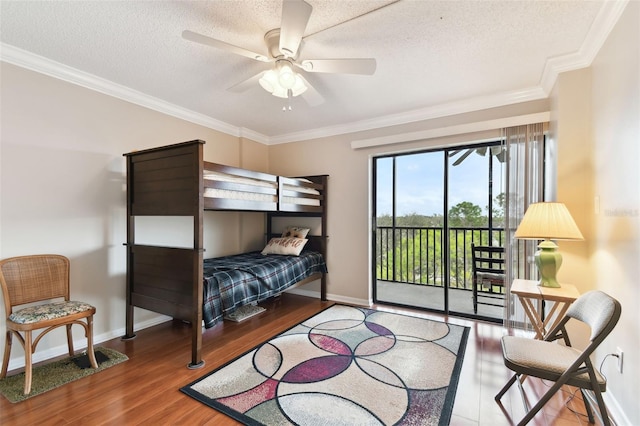 bedroom with access to exterior, crown molding, a textured ceiling, and wood finished floors