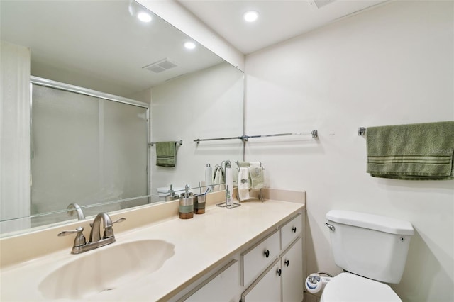 full bathroom featuring visible vents, toilet, an enclosed shower, vanity, and recessed lighting