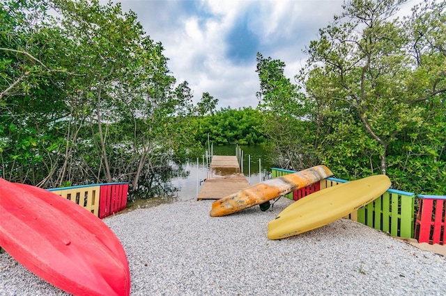 view of jungle gym featuring a dock and a water view