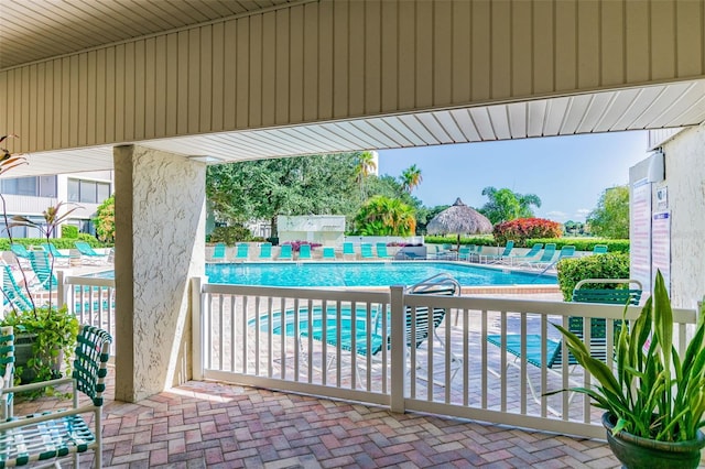 community pool featuring a patio and fence