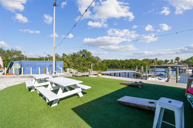 dock area featuring a water view and a lawn