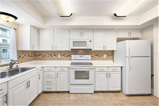 kitchen featuring tasteful backsplash, light tile patterned flooring, white appliances, white cabinetry, and a sink