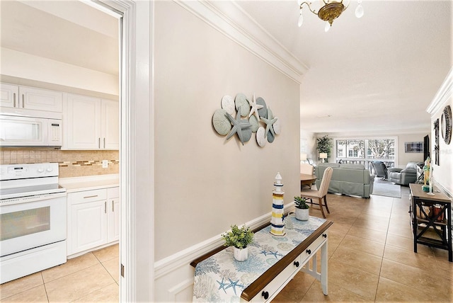 corridor with light tile patterned floors and crown molding