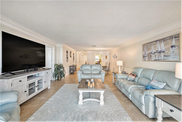 living area with crown molding and a wainscoted wall