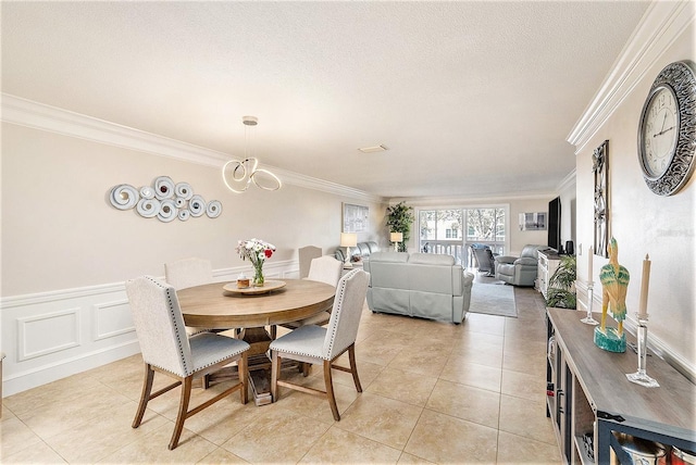 139 Bluff View Dr Unit 105, Belleair Bluffs, FL 33770 - dining room with crown molding, light tile patterned floors, a notable chandelier, and a textured ceiling