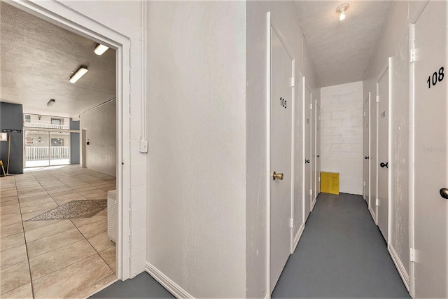 139 Bluff View Dr Unit 105, Belleair Bluffs, FL 33770 - hall featuring baseboards and a textured ceiling