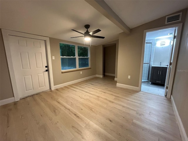 interior space with light wood finished floors, baseboards, visible vents, lofted ceiling with beams, and ceiling fan