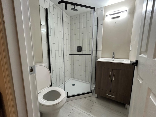 full bath with toilet, vanity, and a shower stall