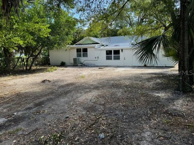 back of property featuring fence