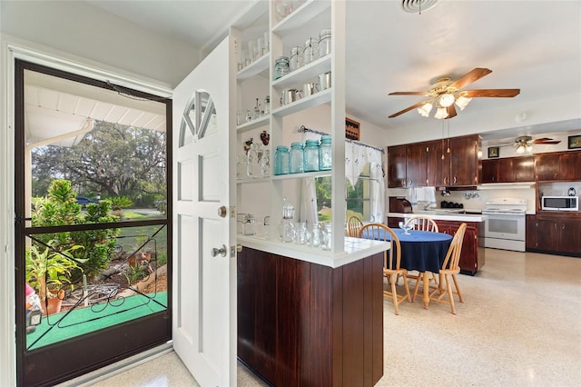 kitchen featuring dark brown cabinetry, a ceiling fan, light countertops, white electric range, and light speckled floor