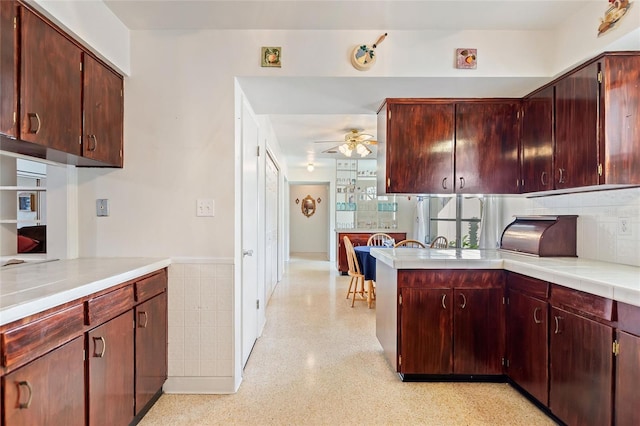 4310 Indian Lake Dr, Indian Lake Estates, FL 33855 - kitchen featuring ceiling fan, light countertops, light speckled floor, and a peninsula
