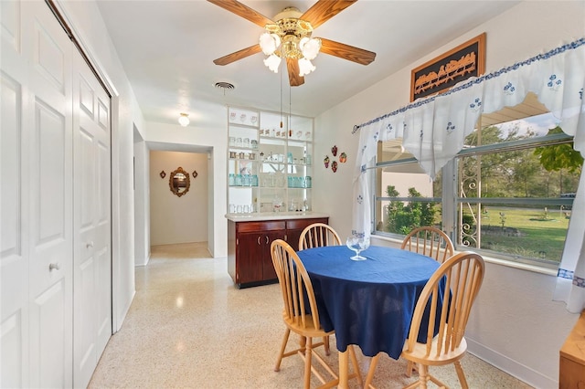 4310 Indian Lake Dr, Indian Lake Estates, FL 33855 - dining area with ceiling fan, visible vents, light speckled floor, and indoor bar