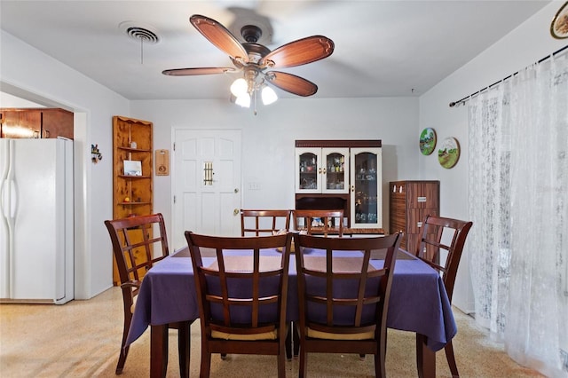4310 Indian Lake Dr, Indian Lake Estates, FL 33855 - dining space featuring light speckled floor, visible vents, and a ceiling fan