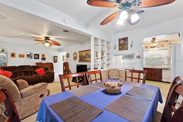 4310 Indian Lake Dr, Indian Lake Estates, FL 33855 - dining room with ceiling fan, light carpet, visible vents, and built in features