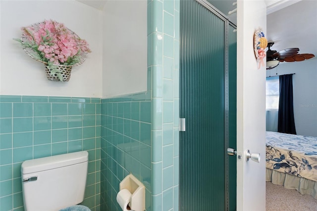 4310 Indian Lake Dr, Indian Lake Estates, FL 33855 - bathroom featuring toilet, ensuite bath, tile walls, wainscoting, and an enclosed shower