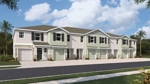 view of front of property featuring a garage, stone siding, concrete driveway, and stucco siding