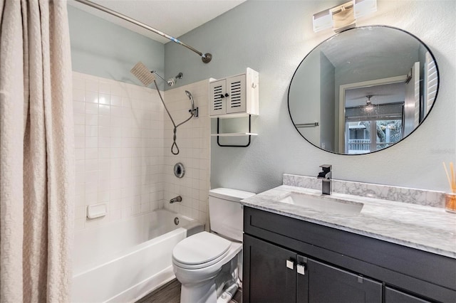 bathroom featuring a textured wall, shower / bathtub combination with curtain, toilet, vanity, and wood finished floors