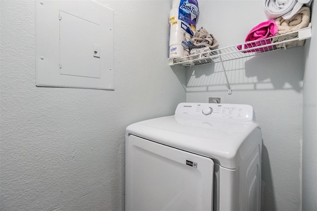 laundry room featuring washer / dryer, laundry area, electric panel, and a textured wall