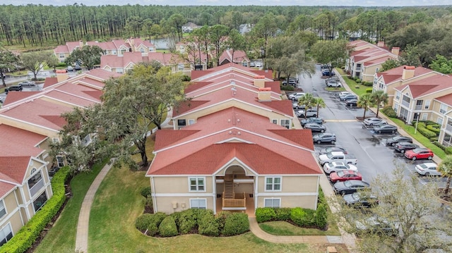 birds eye view of property featuring a wooded view and a residential view