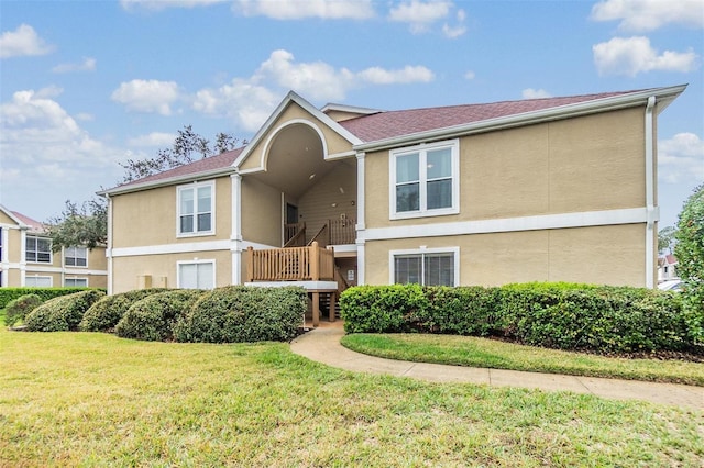 view of front of house featuring a front lawn and stucco siding