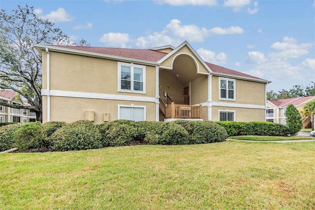 view of front of house featuring a front lawn and stucco siding