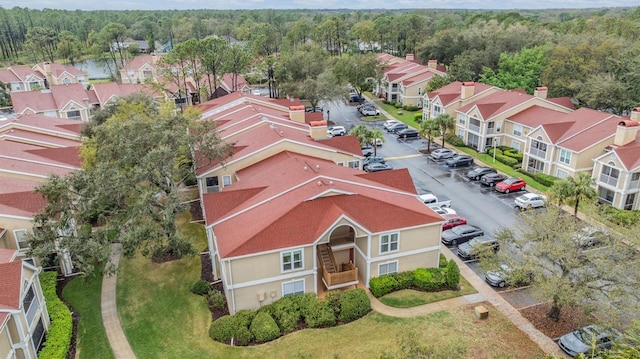 birds eye view of property with a forest view and a residential view