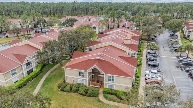 drone / aerial view with a forest view and a residential view