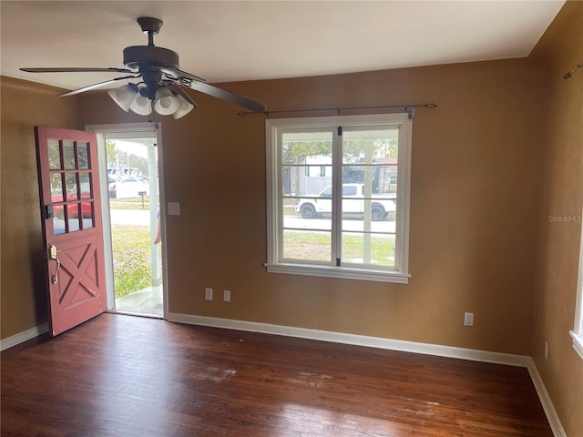 interior space with baseboards, dark wood finished floors, and a healthy amount of sunlight