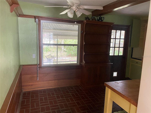 unfurnished dining area featuring a ceiling fan and brick patterned floor