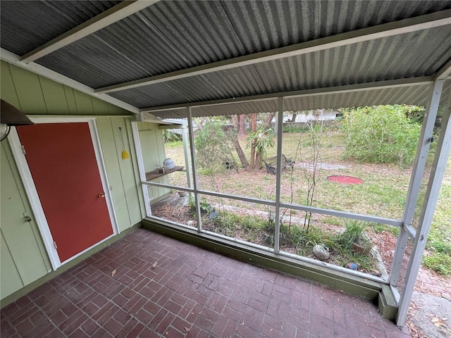 unfurnished sunroom with vaulted ceiling