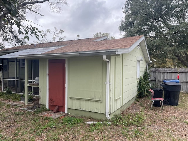 view of outbuilding featuring fence