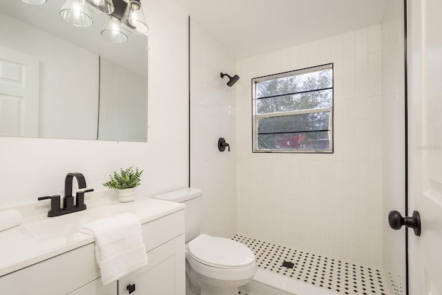 full bathroom with toilet, a shower stall, and vanity