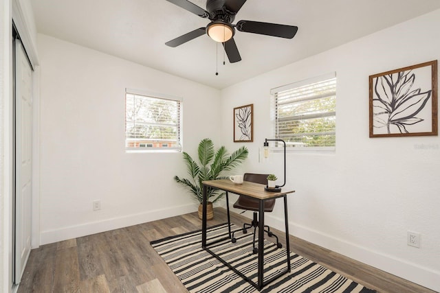 home office with plenty of natural light, wood finished floors, and baseboards