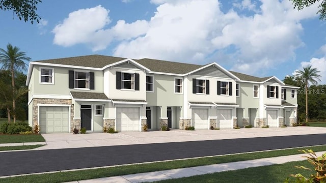 townhome / multi-family property featuring driveway, stone siding, a garage, and stucco siding