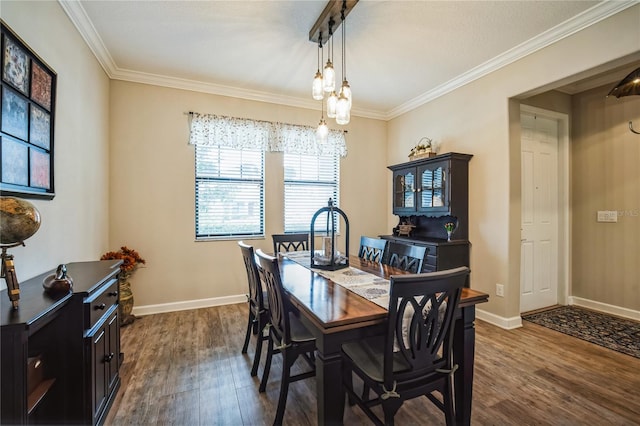 dining area featuring dark wood-type flooring, ornamental molding, and baseboards