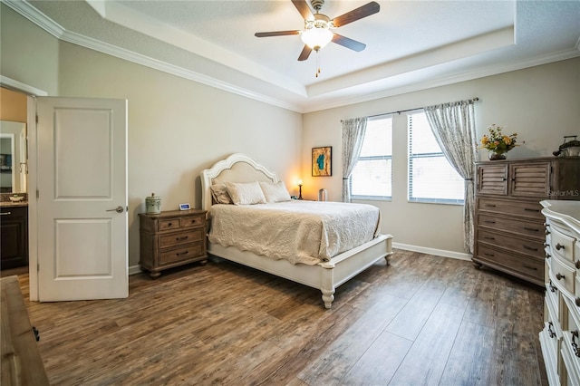 bedroom featuring dark wood-style floors, a raised ceiling, a ceiling fan, and baseboards