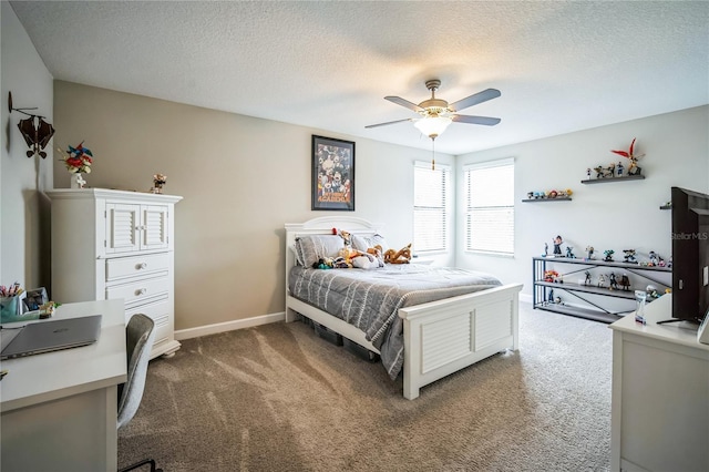 bedroom with ceiling fan, a textured ceiling, carpet flooring, and baseboards