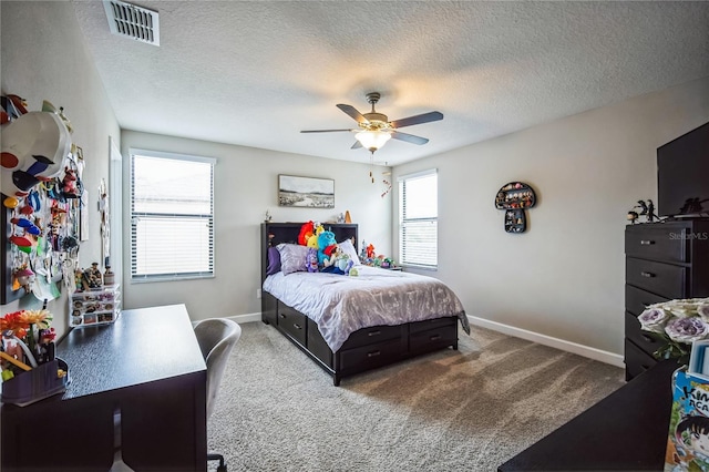 bedroom with a textured ceiling, carpet, visible vents, and baseboards