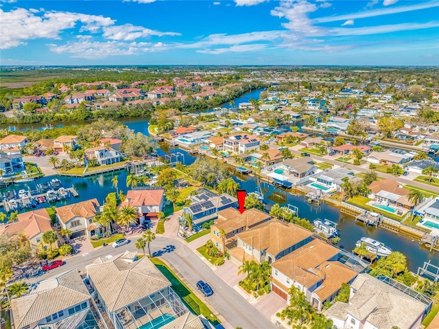 birds eye view of property with a residential view and a water view