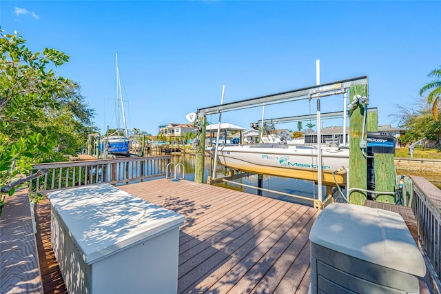 dock area with a water view and boat lift