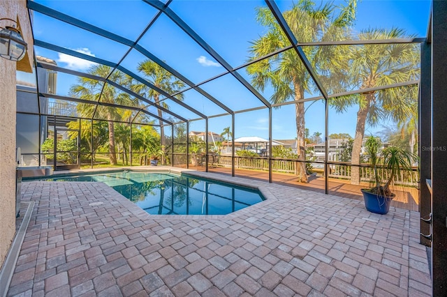 outdoor pool with a patio area and a lanai