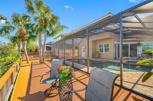 deck featuring a lanai and an outdoor pool