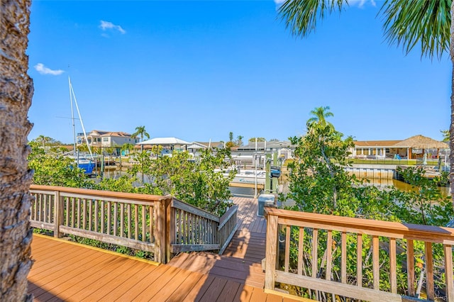 deck featuring a dock, a water view, and boat lift