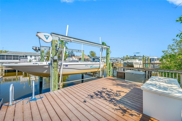 dock area with a water view and boat lift