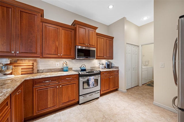 kitchen featuring light stone counters, stainless steel appliances, decorative backsplash, brown cabinetry, and baseboards