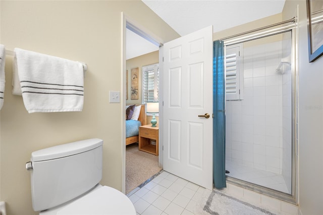 ensuite bathroom featuring toilet, a shower stall, connected bathroom, and tile patterned floors