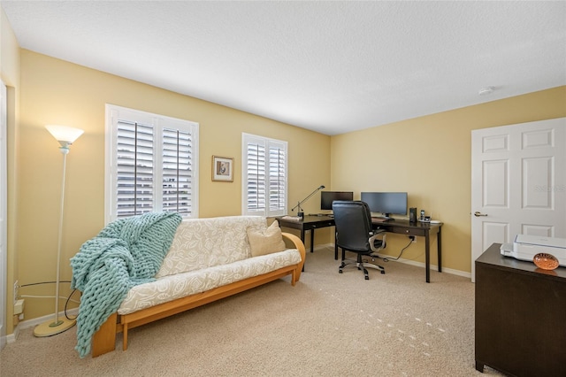 home office featuring a textured ceiling, carpet floors, and baseboards