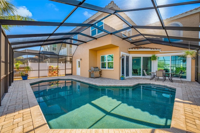 view of swimming pool with a fenced in pool, a lanai, and a patio area